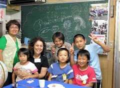 Gail with young students in Japan